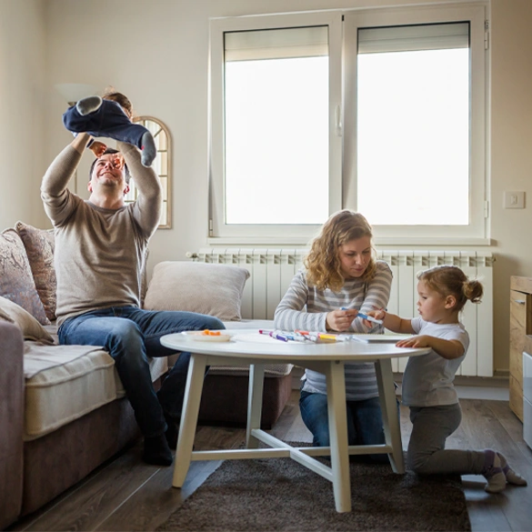 Family spending time together at home, representing financial stability and savings flexibility with a money market account.
