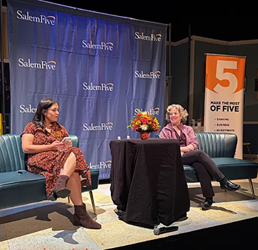 Two speakers seated on stage at a Salem Five event.
