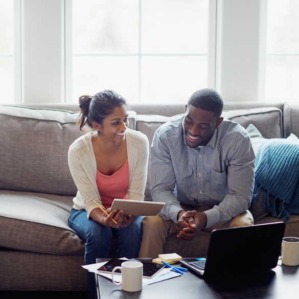 Couple sitting on couch discussing financing